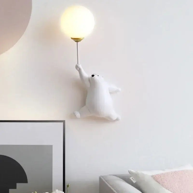 White polar bear wall lamp with spherical frosted glass shade and gold metal fixture for kids bedroom decor