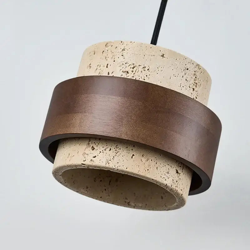Modern pendant light with textured beige concrete body and walnut wood finish ring accents for dining room