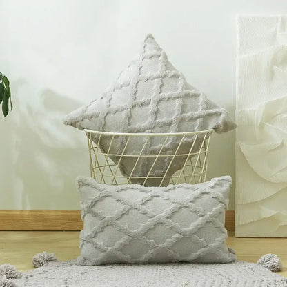 A soft light gray cushion cover with diamond solid embroidery and pom-pom accents for modern living room decor