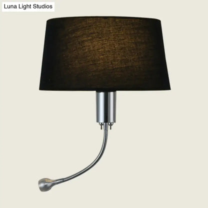 Black fabric flush wall sconce with sleek chrome adjustable arm and head for modern bedroom reading light