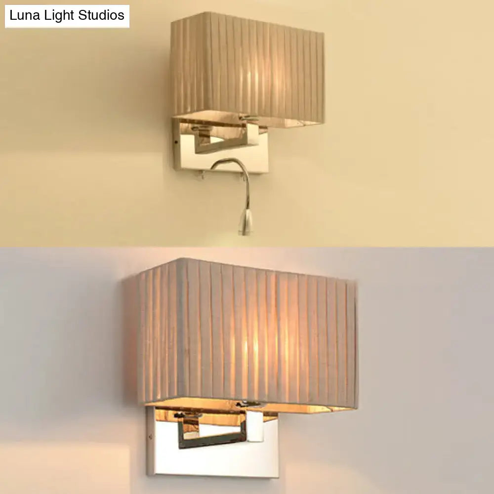 Rectangular wired electric wall sconce with pleated beige fabric shade and polished chrome frame for bedroom lighting