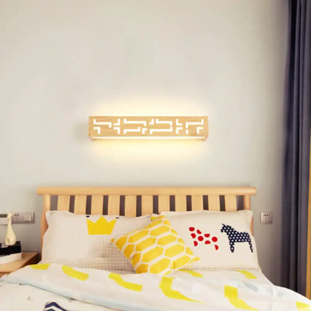Modern beige geometric wooden wall lamp with cutout pattern providing warm diffused light for bathroom use