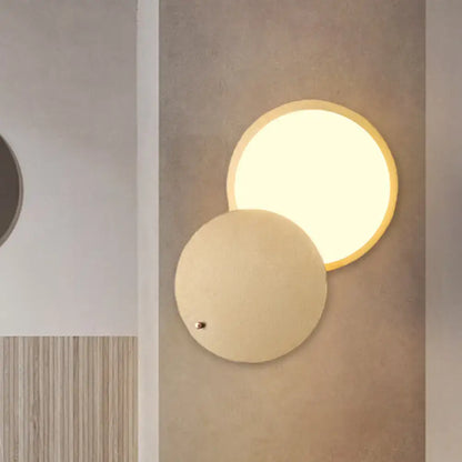 Modern beige and gold metal wall lamp with rotatable led and overlapping disc shades for bedroom sconce lighting