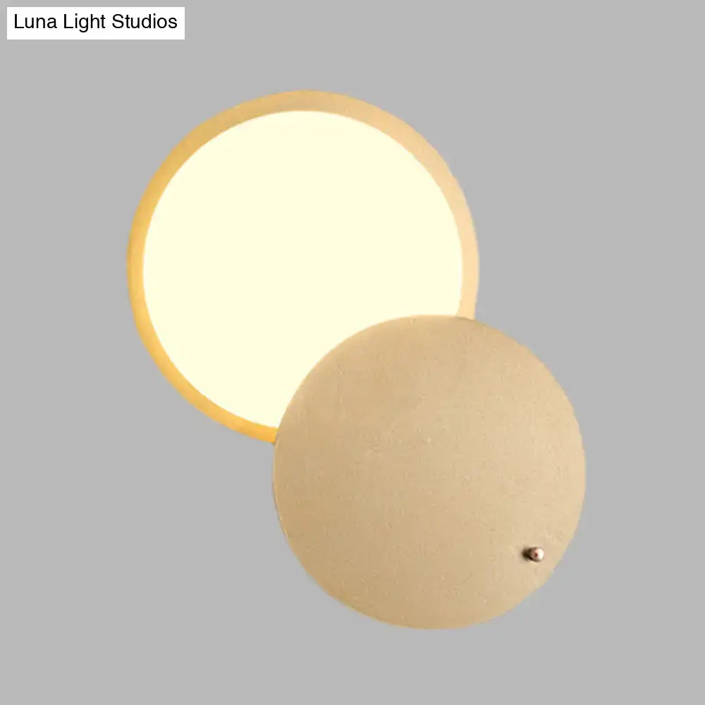 Modern beige and gold metal wall lamp with rotatable led and warm diffused circular ceiling light glow