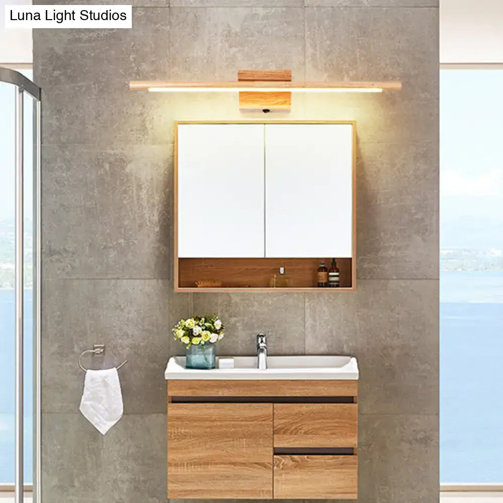 Modern wooden vanity with white countertop and sink illuminated by a beige stick shaped led vanity sconce wall light