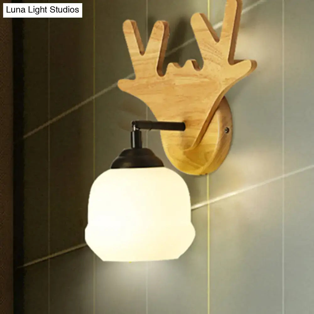 Modern beige wood deer head wall light featuring a wooden deer head fixture with a frosted glass globe shade