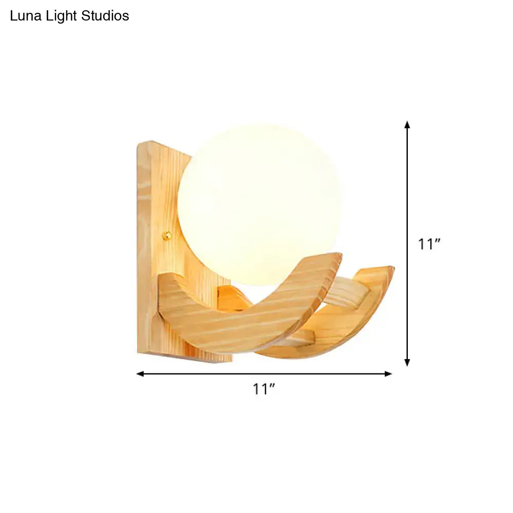 Modern beige wood sconce light fixture with a warm spherical glass shade and curved natural wood arms wall lamp