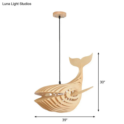 Modern hanging light featuring a light beige wooden whale kids pendant lamp with sleek skeletal design and cut-out patterns