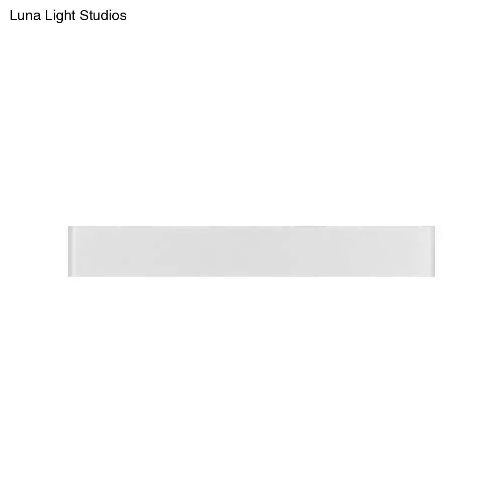 A sleek white ceramic tile with glossy finish paired with a modern black 12 inch led vanity wall sconce