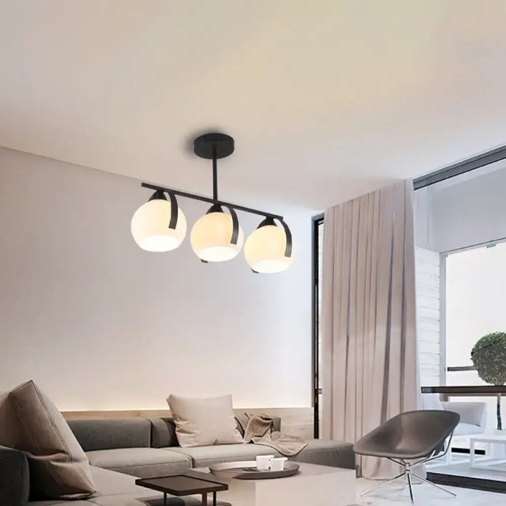 Modern black metal chandelier with three frosted white glass globes compatible with led incandescent fluorescent bulbs ideal for kitchen islands
