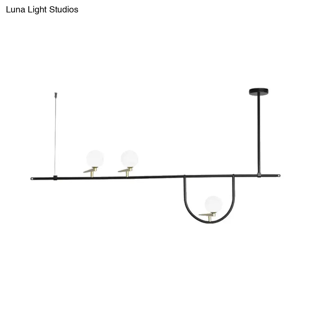 Modern black 3 head kitchen island light with opal glass shade featuring three frosted glass globe shades