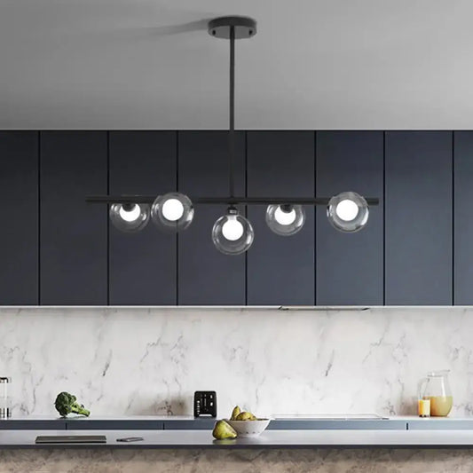 Modern black metal chandelier with five clear glass globe shades for dining room pendant lighting
