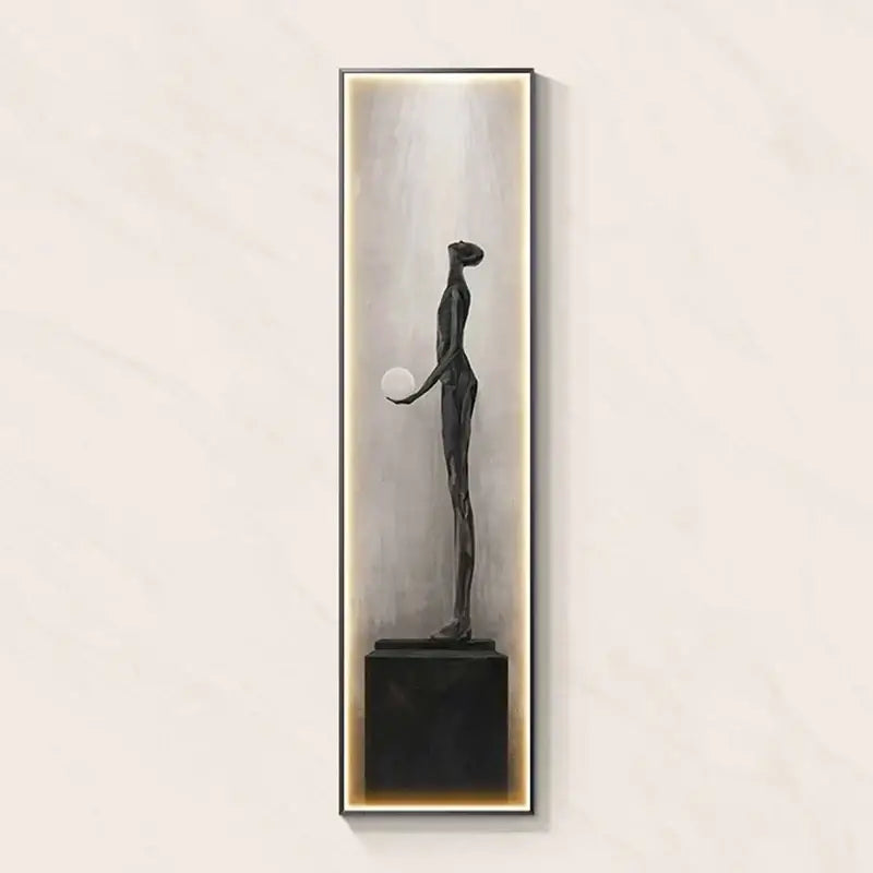 Modern black abstract art led wall lamp featuring a dark bronze sculpture holding a sphere in an illuminated frame for decorbites decor
