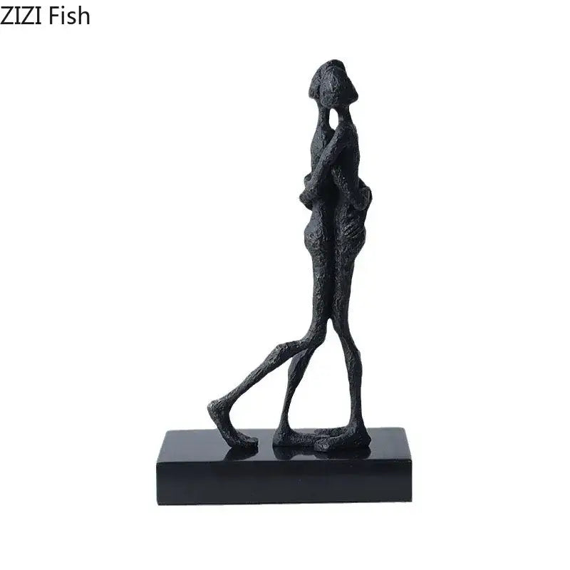 Black abstract lovers sculpture desk ornament featuring two figures in embrace on a sleek black base