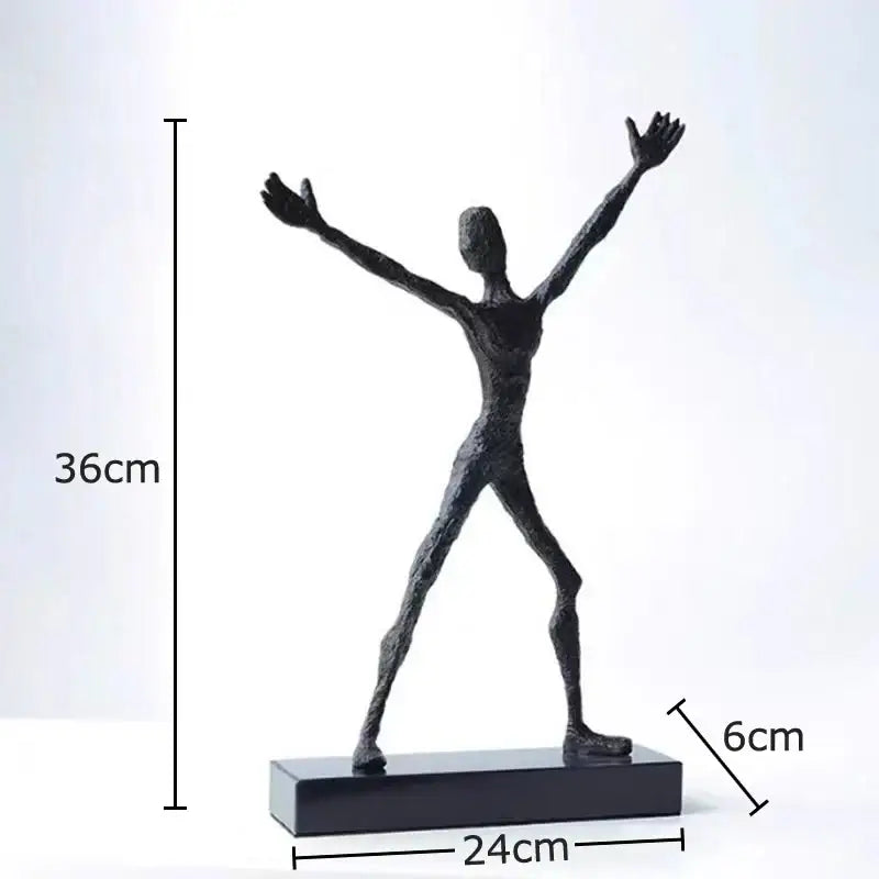 Black abstract lovers sculpture with outstretched arms and legs on rectangular base as modern desk ornament