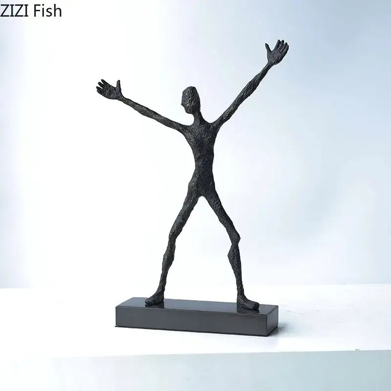 Black textured abstract lovers sculpture with arms outstretched on a rectangular base as a sculpture desk ornament