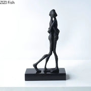 Modern black matte abstract lovers sculpture desk ornament featuring two figures in an embrace on a rectangular base