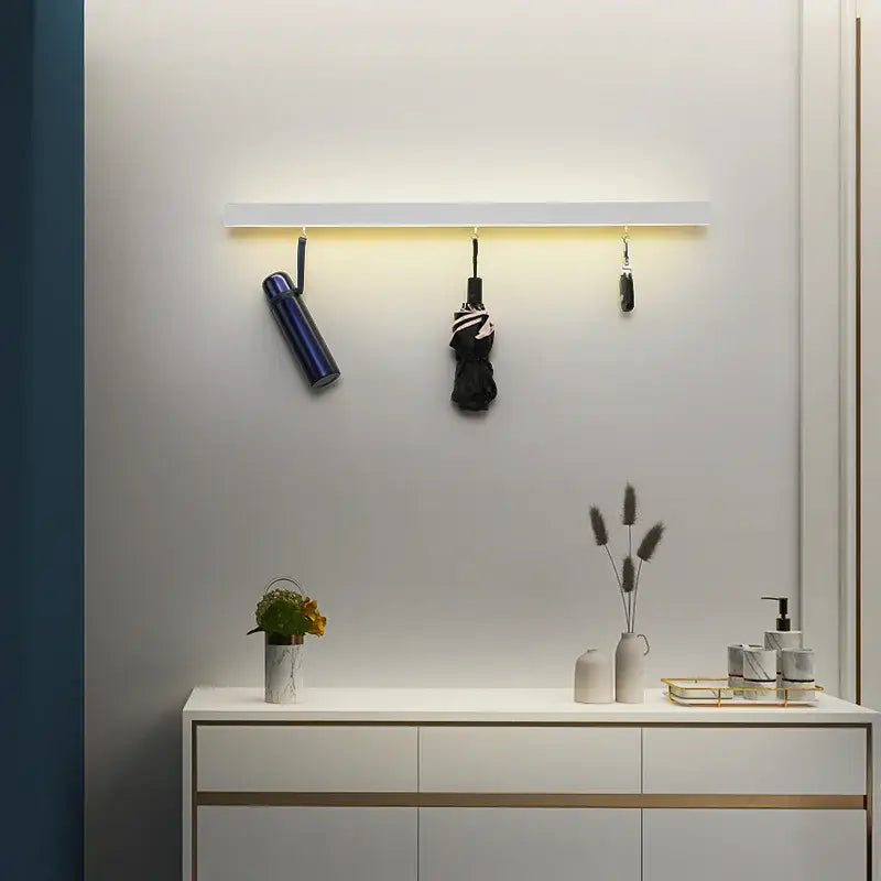 White wall-mounted acrylic led wall lamp with integrated led strip lighting and three hanging hooks for bedroom decorbites acrylic led