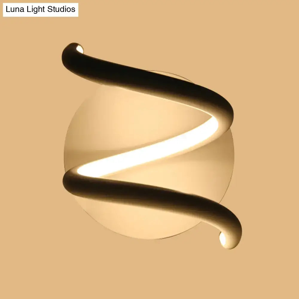 Modern black acrylic spiral sconce light fixture with sleek design and warm glowing light for bedroom lighting