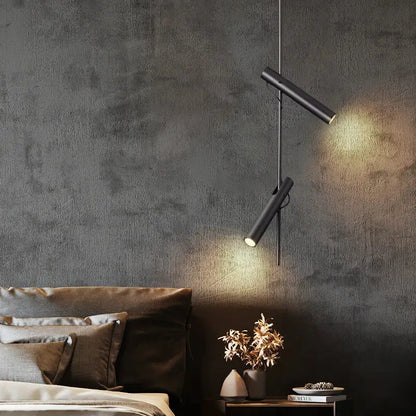 Modern black adjustable led pendant chandelier with cylindrical pendant chandelier lights hanging against gray wall