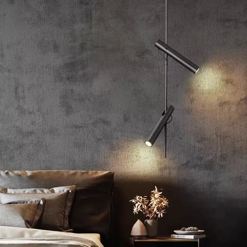 Modern black adjustable led spot bedroom pendant with black cylindrical decorbites black adjustable lights hanging against dark wall