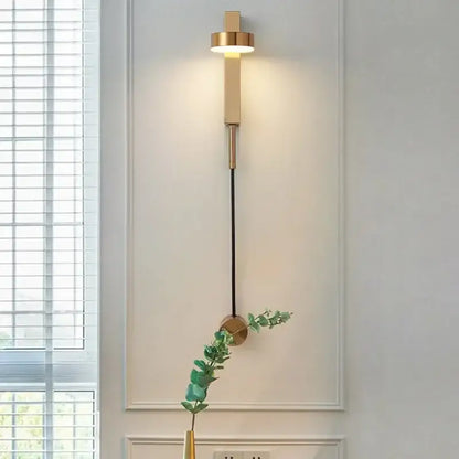 Modern gold-toned wall lamp with cylindrical adjustable led fixture and black cord for decorbites adjustable led wall lighting