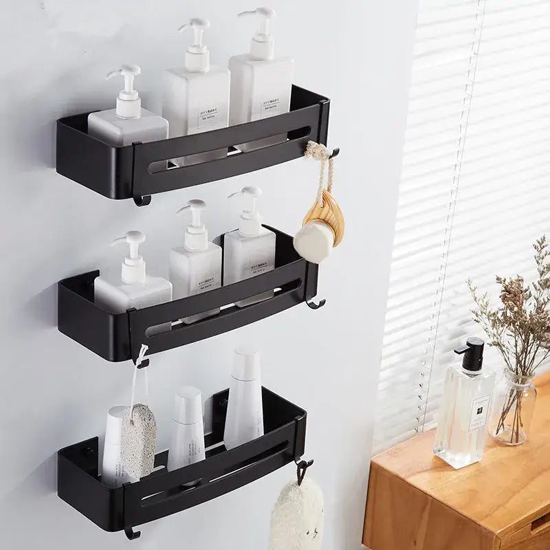 Modern black aluminum corner shelf with three tiers holding white pump bottles and hooks for bath accessories decorbites black aluminum wall