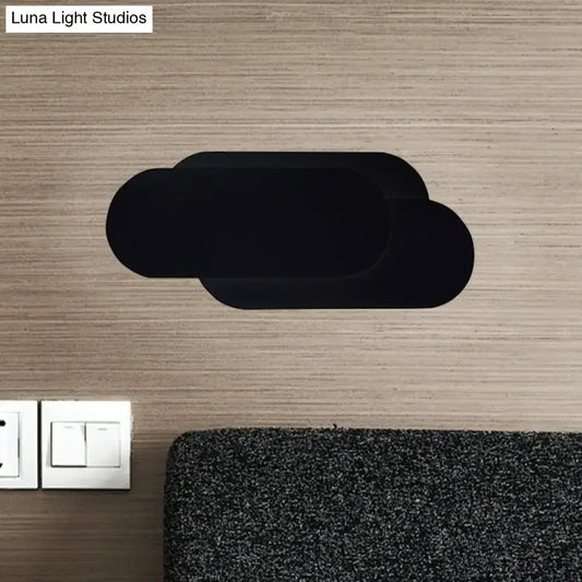 Modern black aluminum oval wall washer lamp with black cloud-shaped wall decal for bedroom lighting