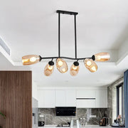Modern black metal island pendant light with five amber glass shades and branch design for ceiling hanging fixture