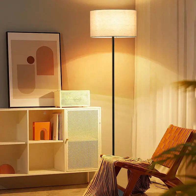 Modern black and beige led vertical floor lamp with cylindrical fabric shade and sleek metal pole for living room use