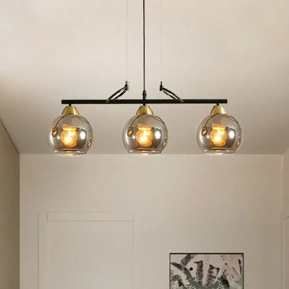 DecorBites™ contemporary 3-bulb black metal bar pendant light with smoke gray glass shades and brass accents for hall island