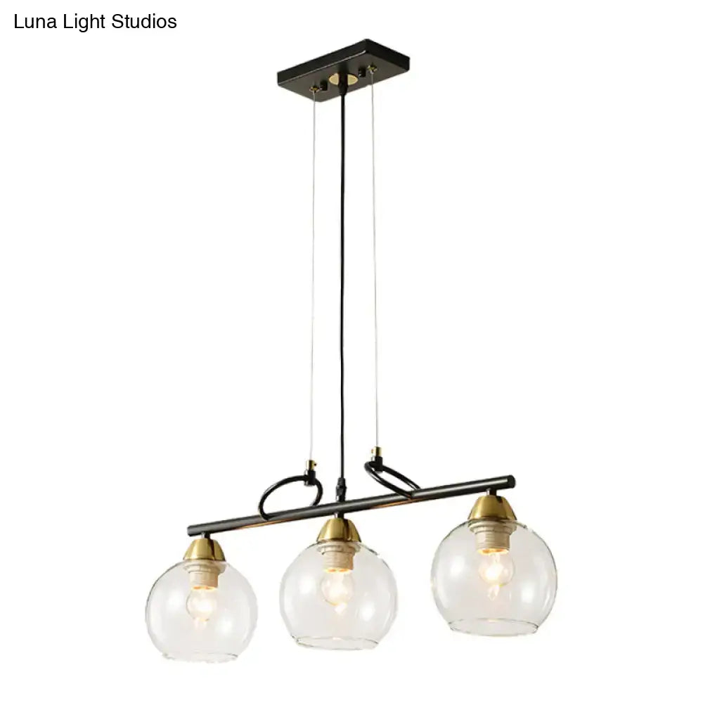 DecorBites™ black metal chandelier with three clear smoke gray glass globes and brass accents for hall island lighting
