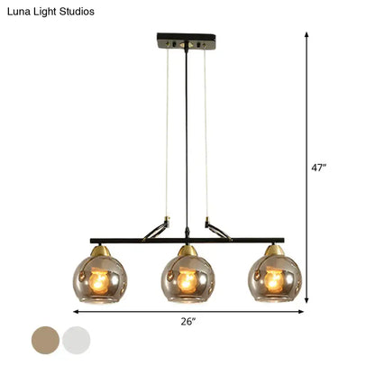 DecorBites contemporary black metal 3-bulb pendant light with smoke gray glass and brass accents for hall island