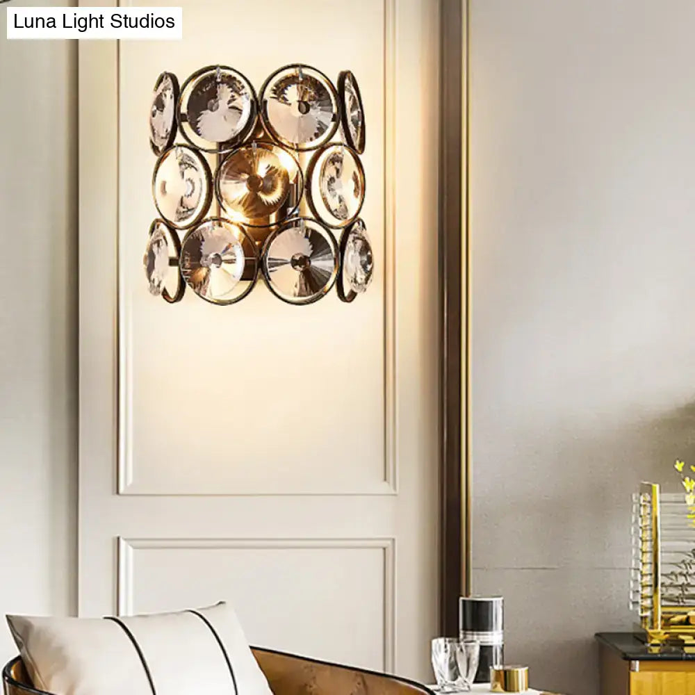 Modern black and brass crystal wall mount light with mirrored glass discs and gold-toned frames for bedroom use