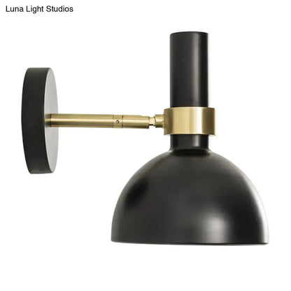 Modern black and brass domed wall lamp with matte finish and brass accents ideal as a bedroom bedside wall lamp