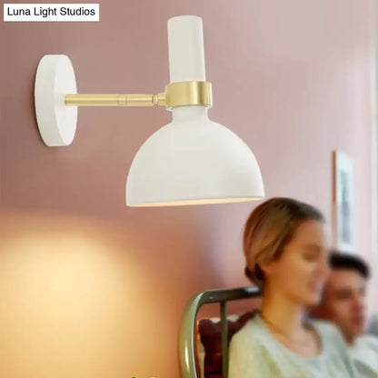 White ceramic wall sconce with gold-toned metal arm for modern black and brass domed wall lamp bedside lighting