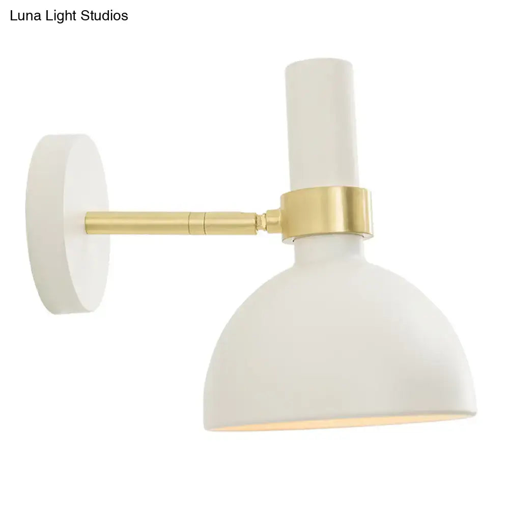 Modern black and brass domed wall lamp with white matte-finished adjustable arm ideal for bedroom bedside lighting
