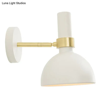 Modern black and brass domed wall lamp with white matte-finished adjustable arm ideal for bedroom bedside lighting