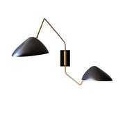 Modern black matte duckbill reading wall light with brass-colored articulated metal arms for bedroom use
