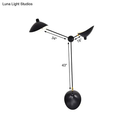 Modern black and brass duckbill wall lamp with three arms metallic shade and compact fixture height for living room use