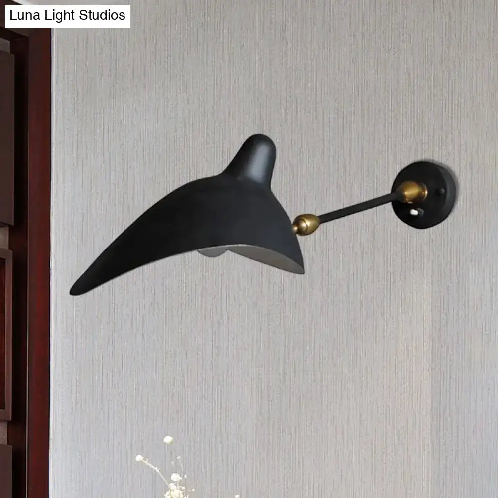 Modern black and brass wall lamp with sleek curved design and metallic shade ideal for living room fixture height