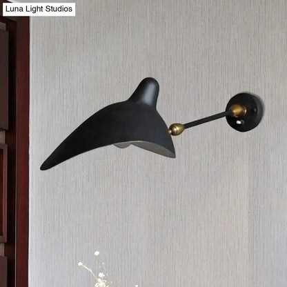Modern black and brass wall lamp with sleek curved design and metallic shade ideal for living room fixture height