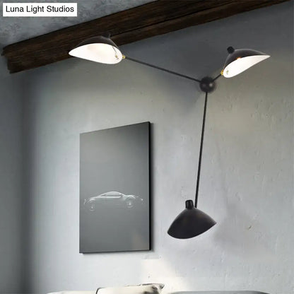 Modern black and brass wall lamp with metallic shades and fixture height featuring two upward and one downward conical shade
