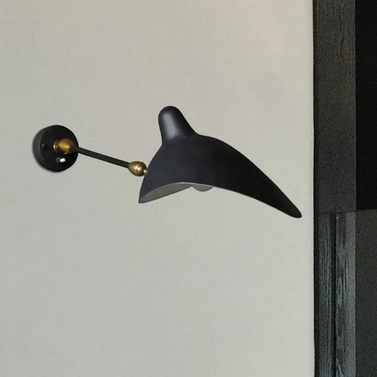 Modern black and brass wall lamp with metallic shade and sleek curved duckbill design for living room fixture height