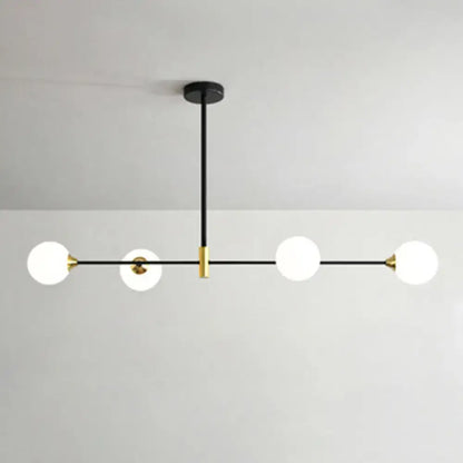 Modern black and brass metal island pendant with four frosted glass globe bulbs and adjustable chain cord length chandelier