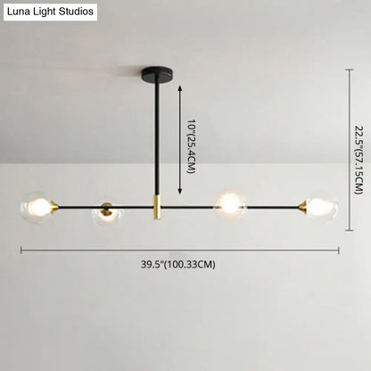 Modern black metal island pendant chandelier with brass accents and four clear glass globe bulbs with chain cord length