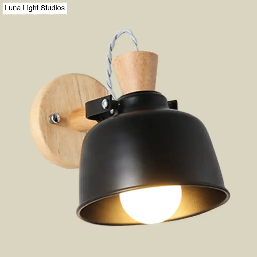 Modern black metal wall light with wooden circular backplate cork accent and exposed bulb in matte shade for bedroom