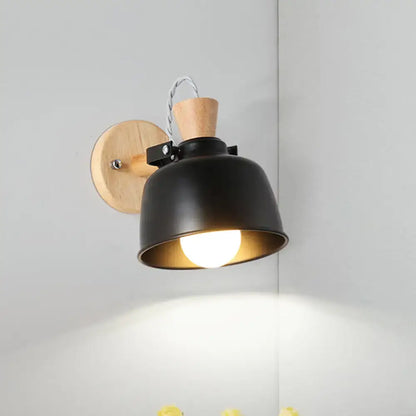 Modern black and brass metal wall light bedroom sconce with adjustable arm wood backplate and brass interior