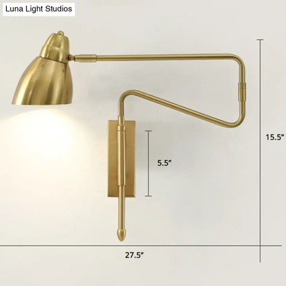 Brass-finished adjustable wall light with black backplate width and bulb base ideal for bedroom or studio task lighting