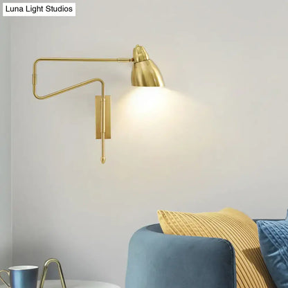 Modern black and brass wall light with gold-finished articulated arm and standard bulb base for bedroom or studio use